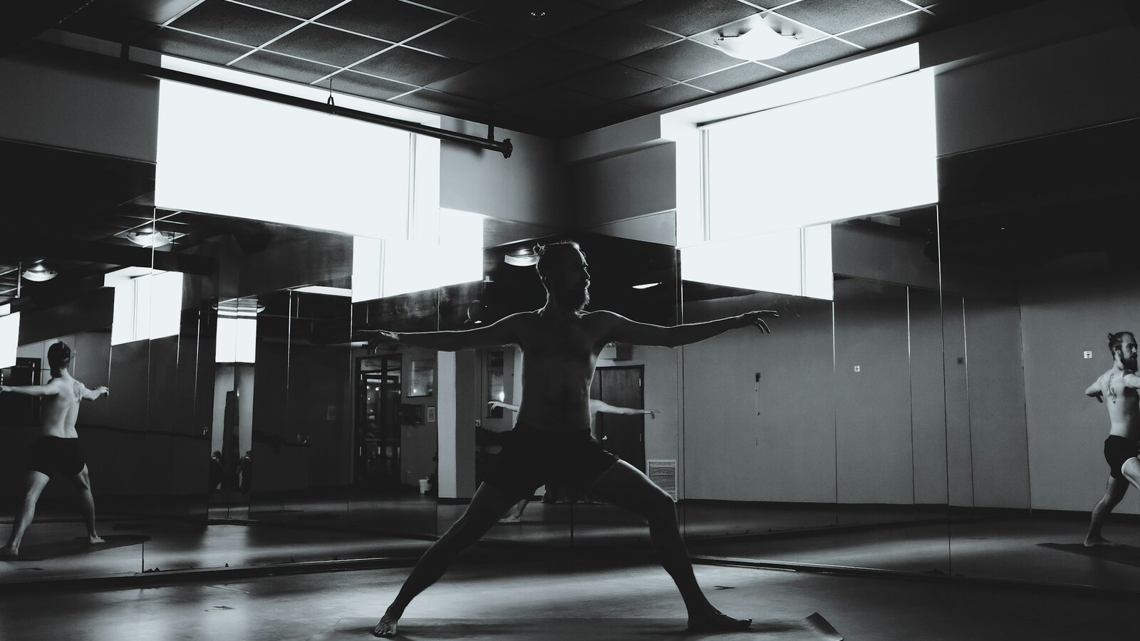 A dancer moving through a mirrored studio